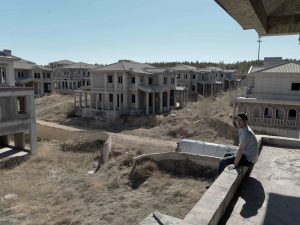 On The Other Side Of Town, Dr. John McGovern Tours An Unfinished Mansion Complex