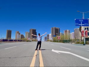Pioneer Media's John McGovern Poses On A Deserted Highway In Ordos Ghost City